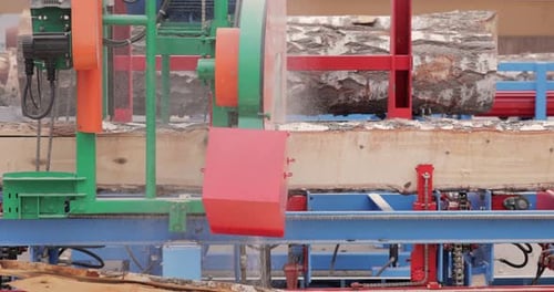 Work of the sawmill in close-up. Process of machining logs in equipment sawmill machine saw saws the