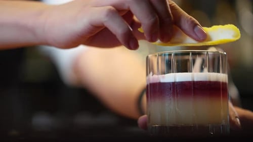 4K Male bartender preparing alcoholic drink serving to customer at restaurant bar.