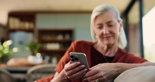 Senior Woman Relaxing at Home Uses Mobile Phone