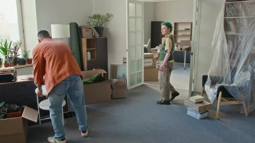 Young Adults Moving Boxes into New Home