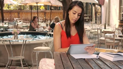 Young Adults Working Together at Outdoor Cafe