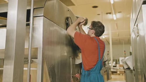 Young Worker Sets Up A Mechanism Mechanic Factory Knot And Chain Setup