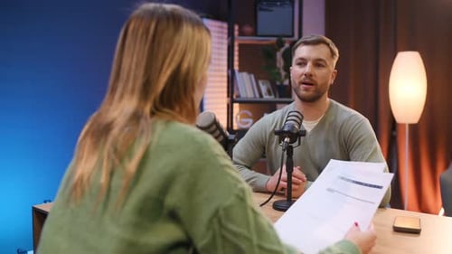 Active conversation. Radio hosts recording podcast.