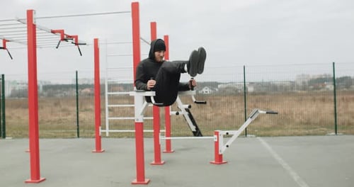 Training Motivation Athlete Man Working Out Outside on the Outdoor Gym Doing Abs Work Out Strong Fit