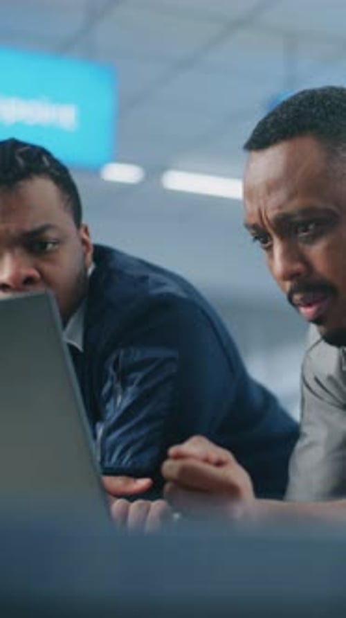 Airport Security Checkpoint Security Officers Using Laptop Computer and Talking