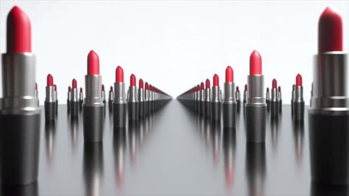 Sleek Red Lipstick Tubes Rotating Slowly on Reflective Surface Positioned Against Pristine White