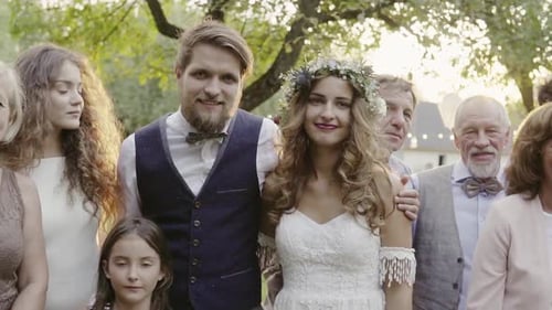 Wedding party poses for outdoor garden photograph