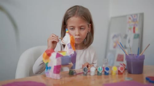 Girl Painting Colorful Unicorn Craft Project Indoors