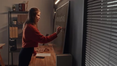 Young Teacher Getting Chalkboard Ready for Music Lesson