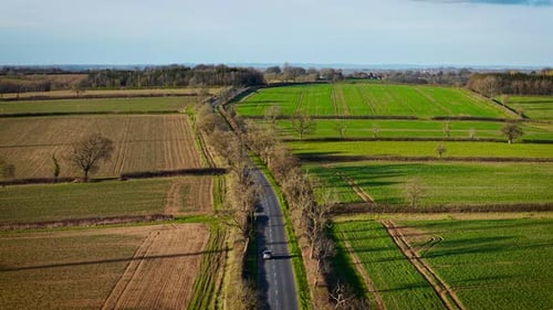 Car Driving Through Countryside Road Vehicle Moving Along Rural Route Driving Down Quiet Farmland