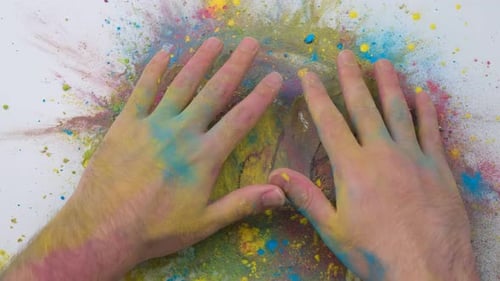 Hands Pressing Into Burst of Holi Powder Paints