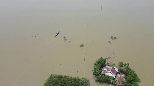 Boat Across Flooded Village In Bangladesh, South Asia. Aerial Drone Shot