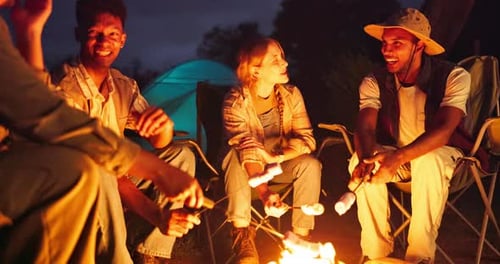 Friends Gather 'Round Campfire Roasting Marshmallows