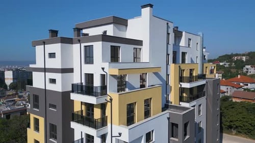 Aerial Drone Shot Orbiting a Modern Residential Building with Clean Architecture Large Windows and