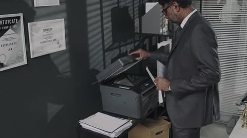Lawyer Making Copy of Legal Documents in Office