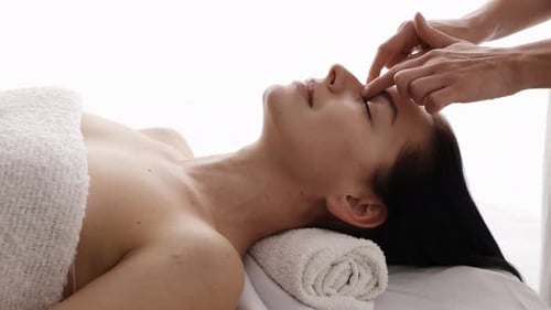 Woman Receives Relaxing Head and Face Massage