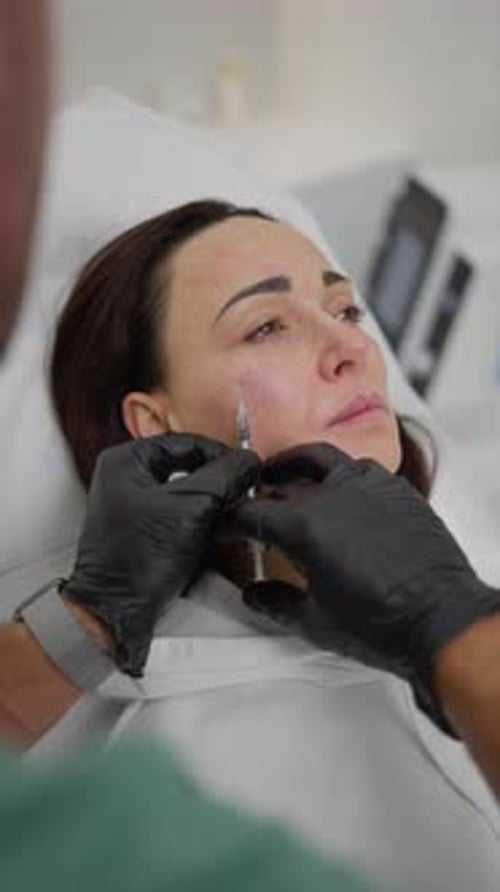 Dermal Filler Procedure for Facial Rejuvenation Closeup of Cosmetologist Carefully Injects Dermal