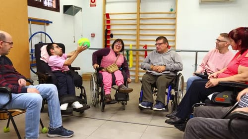 Group of People with Disabilities Playing Ball in a Rehabilitation Center