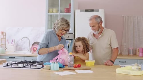 Grandparents Preparing Granddaughter's School Lunch in Slow Motion