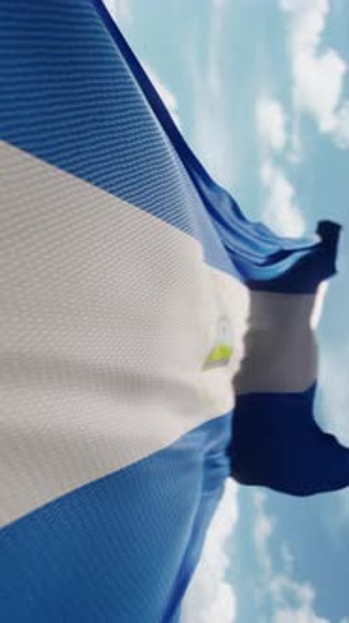 Waving Nicaragua National Flag Against Blue Sky Background