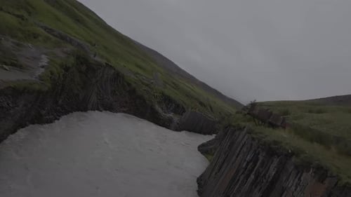Misty River Flow Through Iceland's Rugged Terrain