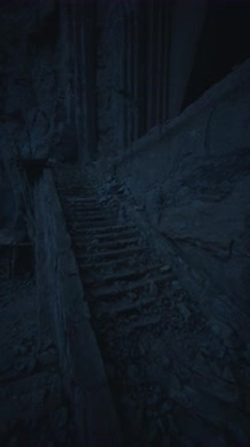 Dark Vertical Journey Down Rocky Steps in a Cave