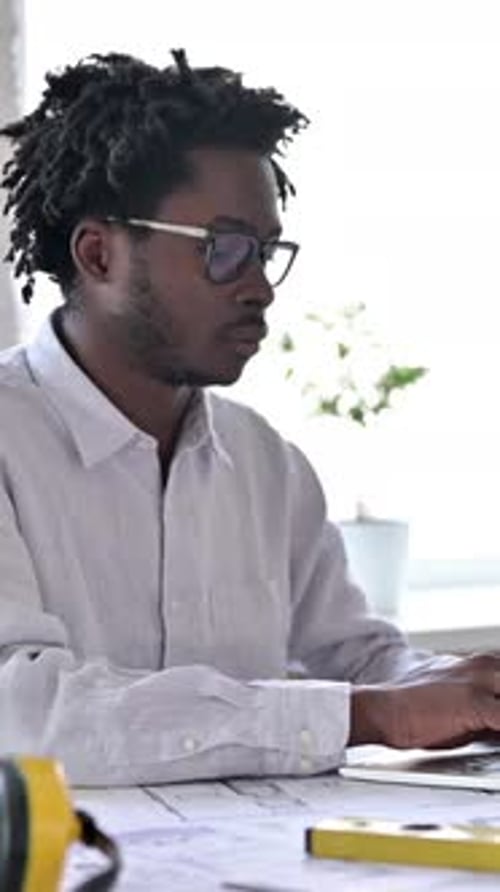 African Engineer Smiling at Camera in Office, vertical video