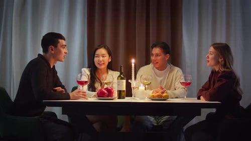 Friends Gather Around Candlelit Table for Dinner Conversation