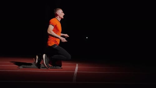 Motivated Sportsman Training In Sprint Lane Professional Runner Standing In Starting Blocks