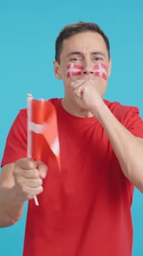 Man Cheering for Denmark During a Match That is Lost