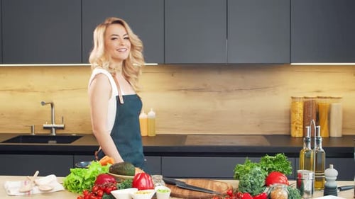 Woman in Kitchen with Vegetables Preparing Food