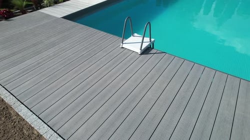 Composite Deck Next to Backyard Swimming Pool