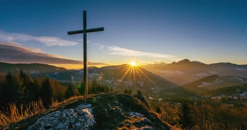 Religious Cross on a Hilltop at Sunrise