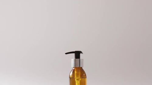 Close up of soap bottle on grey background with copy space