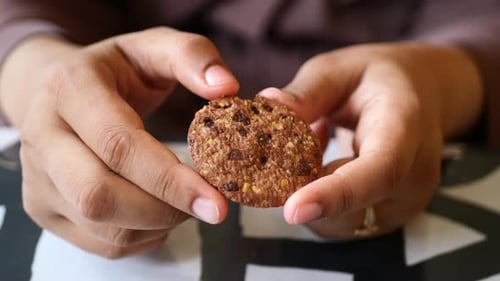 Women Hand Holding a Sweet Cookies