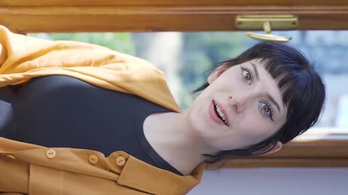 Smiling Young Adult Clapping and Giving Thumbs Up