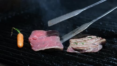 Two Cuts of Steak Cooking on Grill
