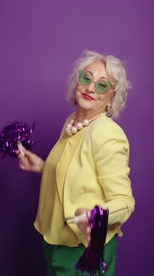 Happy Senior Woman Dancing with Pom Poms