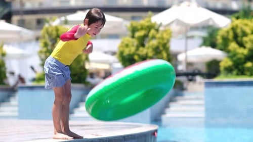 Kid Playful and Jumping in a Swimming Pool Vacation Concept Active Healthy Lifestyle Summer Vacation