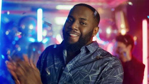 Closeup African Man Winking Eye at Night Club Party. Portrait of Attractive
