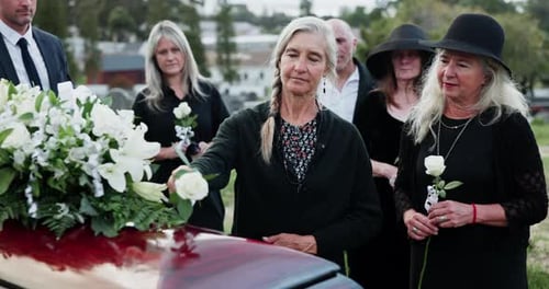 Comfort, casket and people at graveyard for funeral, goodbye and mourning for loss