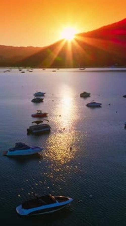 Sun sending last rays from behind the mountains.