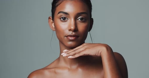 Face, skincare and beauty of Indian woman in studio isolated on gray background