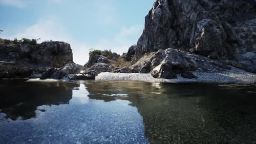 Calm Waters Reflect Rocky Landscape at Noon Near Secluded Riverbank