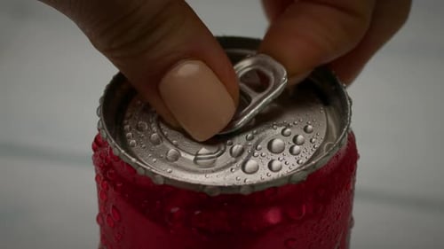 Hand Opens a Refreshing Soda Can Close Up
