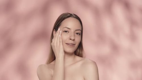 A Woman Touches the Skin Under Her Eyes Runs Her Hand Along Her Slender Neck A Seminude Woman in the