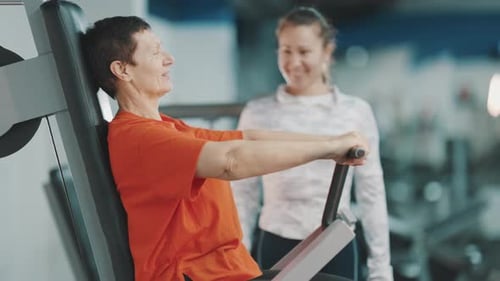 Senior Woman Works Out with Fitness Trainer