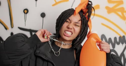 Expressive young woman poses with orange container
