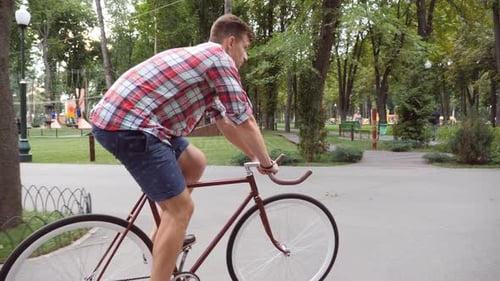 Follow to Young Handsome Man Riding a Vintage Bicycle Outdoor Sporty Guy Cycling at the Park Healthy