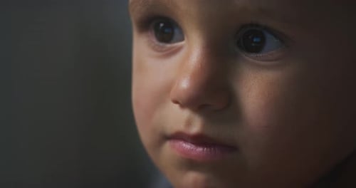 Close Up Portrait of a Little Adorable Child Focused on a Screen. Macro Shot Happy Inf